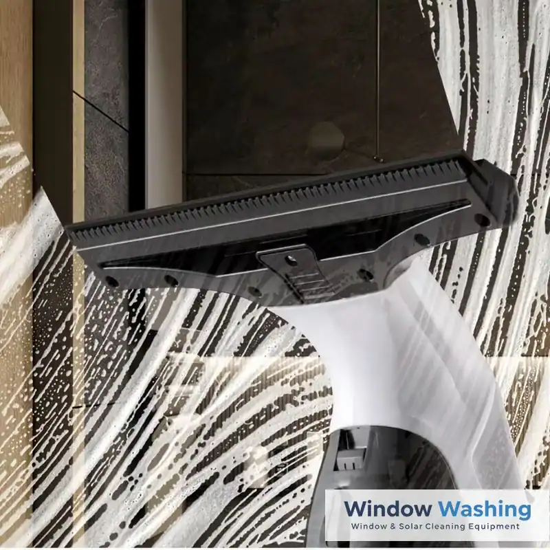 Window vacuum suction head lifting soapy water off glass